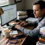 Man tracking crypto portfolio on monitor