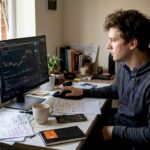 Person reviewing crypto charts at desk
