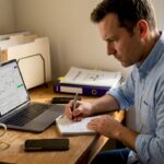 Crypto investor checking laptop in home office